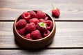 Fresh raspberries in wooden bowl on brown table. Red ripe raspberries, sweet berries Royalty Free Stock Photo