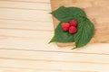 Fresh raspberries in wooden bowl on white table. Top view Royalty Free Stock Photo