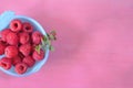 fresh raspberry in blue bowl,on colored background, negative space technique, free copy space