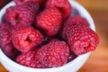 Fresh raspberry on bowl / Close up red raspberries fruit on wood background Royalty Free Stock Photo