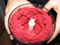 Fresh raspberry chopped in a blender in the hands