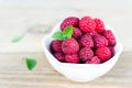 Fresh Raspberry Fruits In White Bowl on Wooden Table Royalty Free Stock Photo