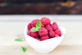 Fresh Raspberry Fruits In White Bowl on Wooden Table Royalty Free Stock Photo