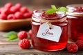 Fresh raspberry jam in jars with berries on wooden table in bright light Generative AI Royalty Free Stock Photo