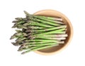 Fresh raw asparagus in wooden bowl isolated, top view Royalty Free Stock Photo