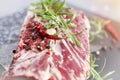 Fresh raw beef flank steak sprinkled with spices, rosmairin and chilli pepper Royalty Free Stock Photo