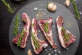 Fresh raw beef and ingredients steak on black stone board over black wooden table