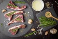 Fresh raw beef and ingredients steak on black stone board over black wooden table