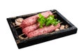 Fresh raw beef meat kebabs sausages on skewers in wooden tray. Isolated on white background. Top view. Royalty Free Stock Photo