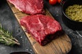 Fresh raw Beef meat Rump Steak, on black dark stone table background Royalty Free Stock Photo