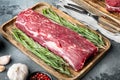 Fresh and raw beef meat. Whole piece of tenderloin with steaks, on gray stone background Royalty Free Stock Photo