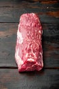 Fresh and raw beef meat. Whole piece of tenderloin with steaks, on old dark wooden table background