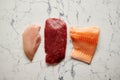 Fresh raw beef steak, chicken breast, and salmon fillet Royalty Free Stock Photo