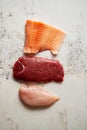 Fresh raw beef steak, chicken breast, and salmon fillet Royalty Free Stock Photo