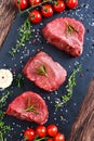 Fresh Raw Beef steak Mignon, with salt, peppercorns, thyme, garlic. Royalty Free Stock Photo