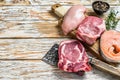 Fresh raw beef striploin steak, chicken breast fillet, pork and salmon steak. White wooden background. Top view. Copy space Royalty Free Stock Photo