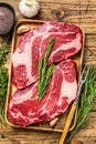 Fresh Raw Black Angus prime beef chuck eye roll steaks. wooden background. Top view