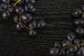 Fresh raw black grape on black wood