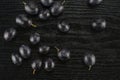 Fresh raw black grape on black wood