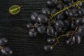 Fresh raw black grape on black wood