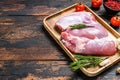 Fresh raw boneless Turkey thigh fillet on a wooden tray. dark background. Top view. Copy space