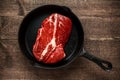 Fresh Raw braising steak in rustic skillet. Royalty Free Stock Photo