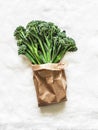 Fresh raw broccolini cabbage in a paper bag on a white background, top view Royalty Free Stock Photo