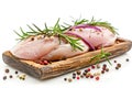 Fresh raw chicken breasts seasoned pepper rosemary red onion wooden tray, isolated. Healthy cooking