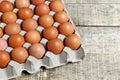 Fresh raw chicken eggs in carton egg box on wood table Royalty Free Stock Photo