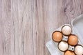 Fresh raw chicken eggs in carton egg box on wooden background Royalty Free Stock Photo