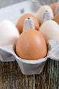 Fresh raw chicken eggs in carton egg box on wooden background. Royalty Free Stock Photo