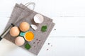 Fresh raw chicken eggs in an cartons egg box. Broken egg, yolk. Organic food for good health high protein. The top view, flat lay