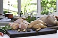 Fresh raw chicken with ingredients for cooking on a wooden cutting board in the kitchen Royalty Free Stock Photo