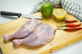 Fresh raw chicken leg quarters on wooden cutting board Royalty Free Stock Photo