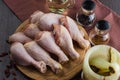 Fresh raw chicken legs arrangement on kitchen cutting board