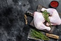 Fresh raw chicken legs on a cutting board. Black background. Top view. Copy space Royalty Free Stock Photo