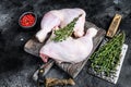 Fresh raw chicken legs on a cutting board. Black background. Top view Royalty Free Stock Photo