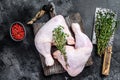 Fresh raw chicken legs on a cutting board. Black background. Top view Royalty Free Stock Photo