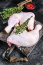 Fresh raw chicken legs on a cutting board. Black background. Top view Royalty Free Stock Photo