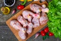 Fresh raw chicken legs on a cutting board with vegetables and spices on wooden background Royalty Free Stock Photo