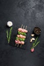 Fresh raw chicken pieces on skewers. Black background. Top view. Space for text Royalty Free Stock Photo