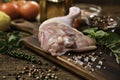 Fresh raw chicken thigh with ingredients for cooking on a wooden cutting board Royalty Free Stock Photo