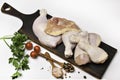 Fresh raw chicken thighs with ingredients for cooking on a wooden cutting board on white background Royalty Free Stock Photo