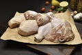 Fresh raw chicken thighs and chicken legs for cooking on a wrapping paper with ingredients on cutting board Royalty Free Stock Photo