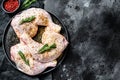 Fresh raw chicken thighs, legs on a cutting Board with spices, cooking. Black background. Top view. Copy space Royalty Free Stock Photo