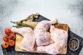 Fresh raw chicken thighs, legs on a cutting Board with spices, cooking. Gray background. Top view. Copy space Royalty Free Stock Photo