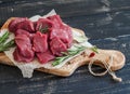 Fresh raw chopped beef, spices and herbs on an olive board Royalty Free Stock Photo