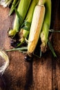 Fresh raw corn cobs on a wooden background. Healthy food, vegetarianism concept Royalty Free Stock Photo