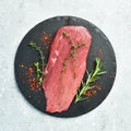 Fresh and raw fillet meat. Whole piece of beef tenderloin steaks set with spices and herbs. Meat.