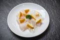 Fresh raw fish fillet piece with lemon on white plate - Close up pangasius dolly fish meat Royalty Free Stock Photo